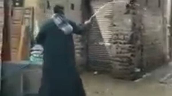 الشاب أثناء رش المياه