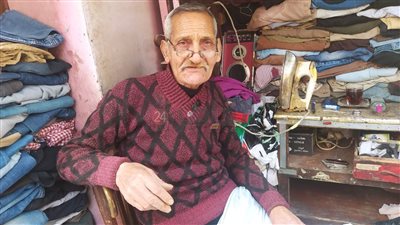 ربنا رزقني بـ 5 أبناء وتكفلت بطفل يتيم.. حكاية عم حسني أقدم صنايعي رفا ملابس ببني سويف|فيديو 